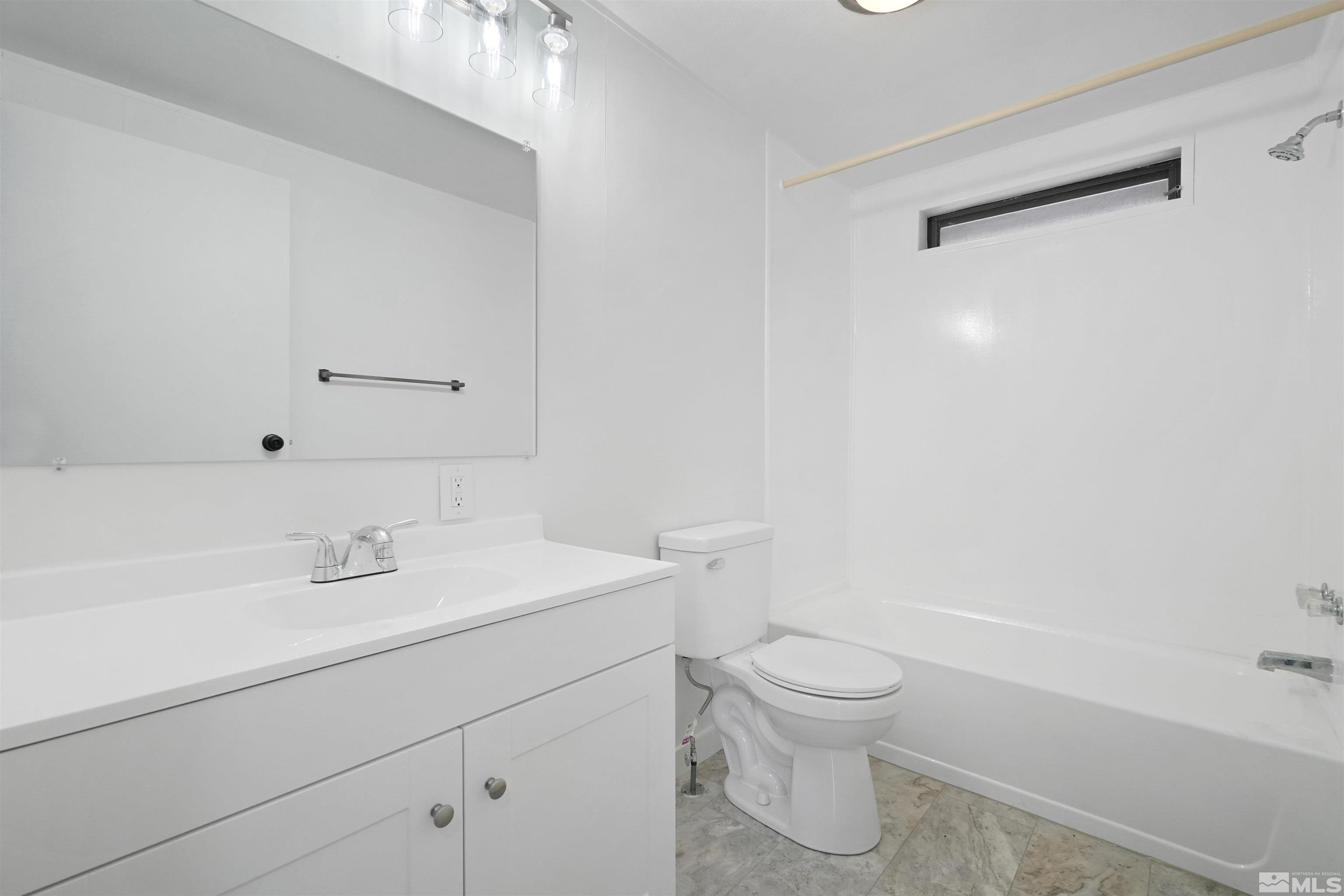 3975 Alcorn Road Fallon, NV 89406 - Photo 18 of 21 a bathroom with a sink a toilet and a bathtub