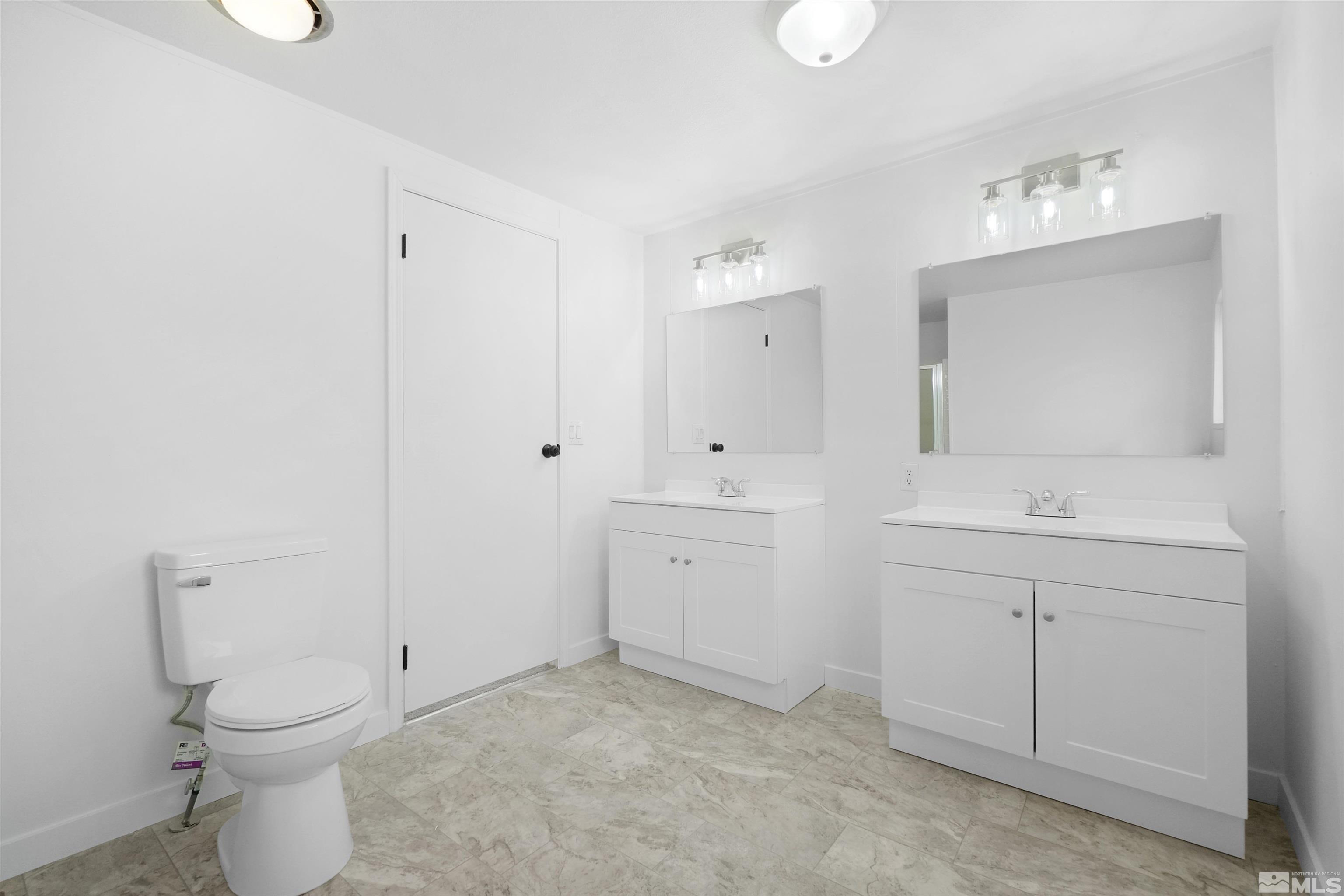 3975 Alcorn Road Fallon, NV 89406 - Photo 19 of 21 a bathroom with a toilet sink and mirror