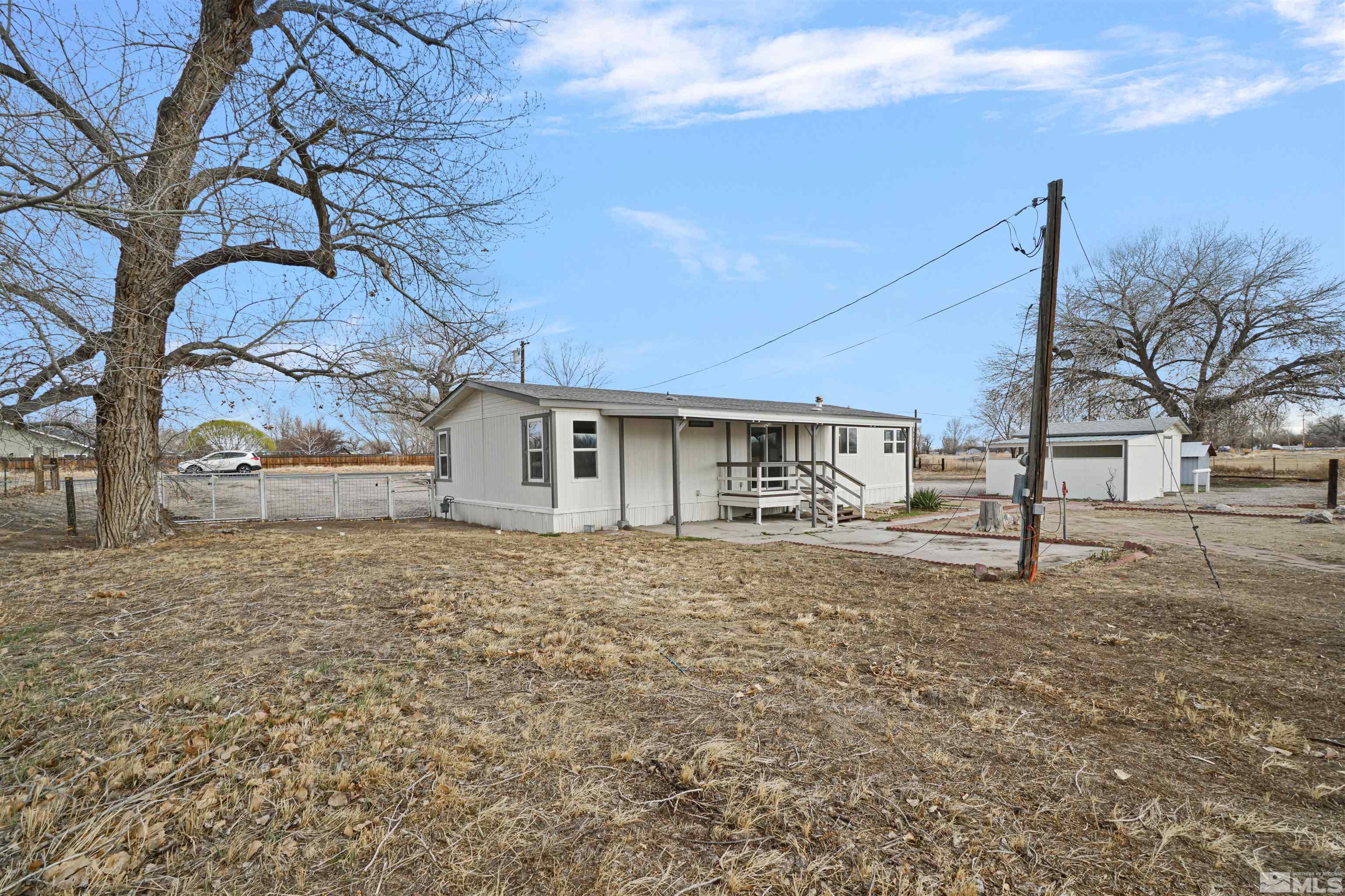 3975 Alcorn Road Fallon, NV 89406 - Photo 2 of 21 a house with trees in the background