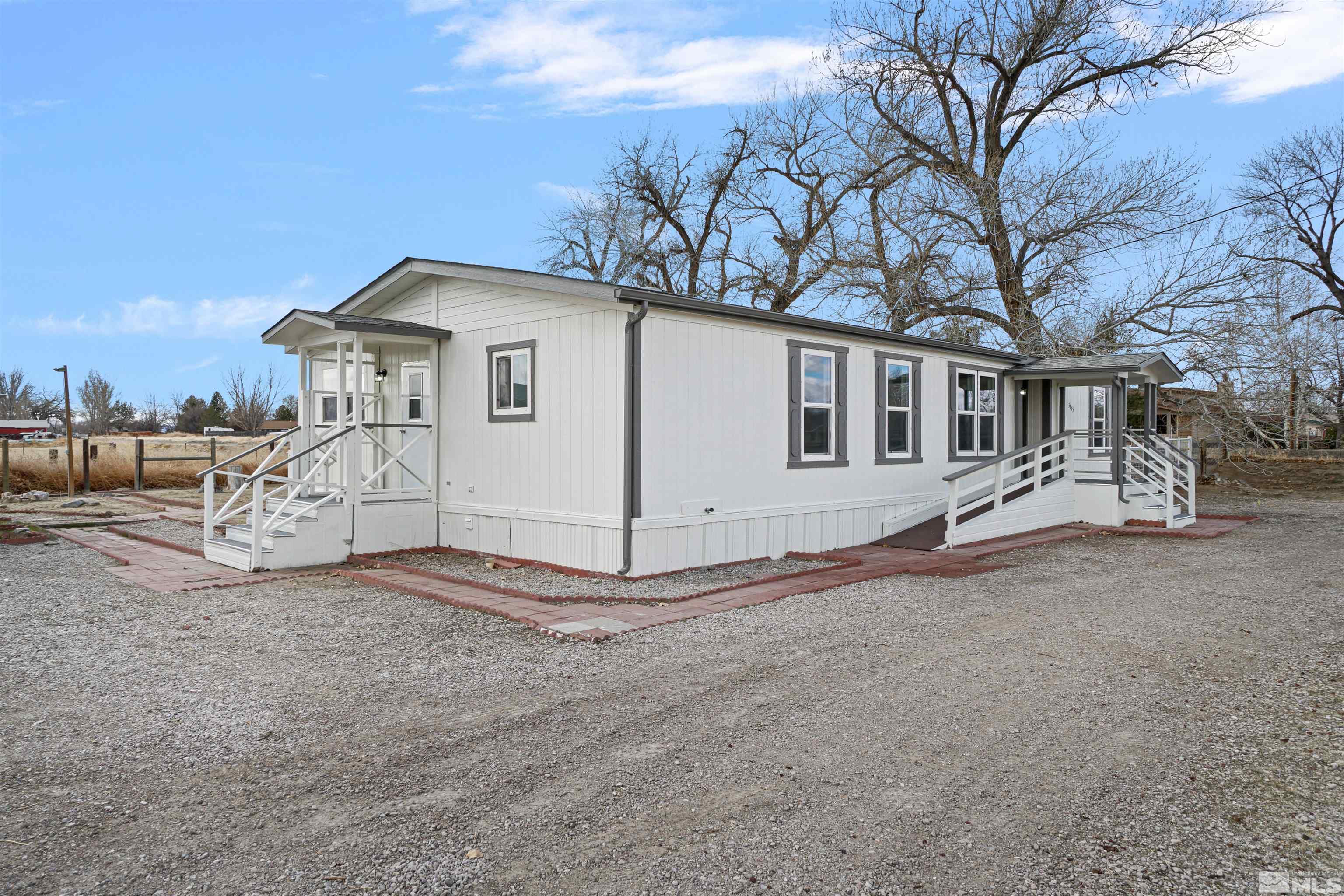 3975 Alcorn Road Fallon, NV 89406 - Photo 21 of 21 a white house with a large tree in front of it