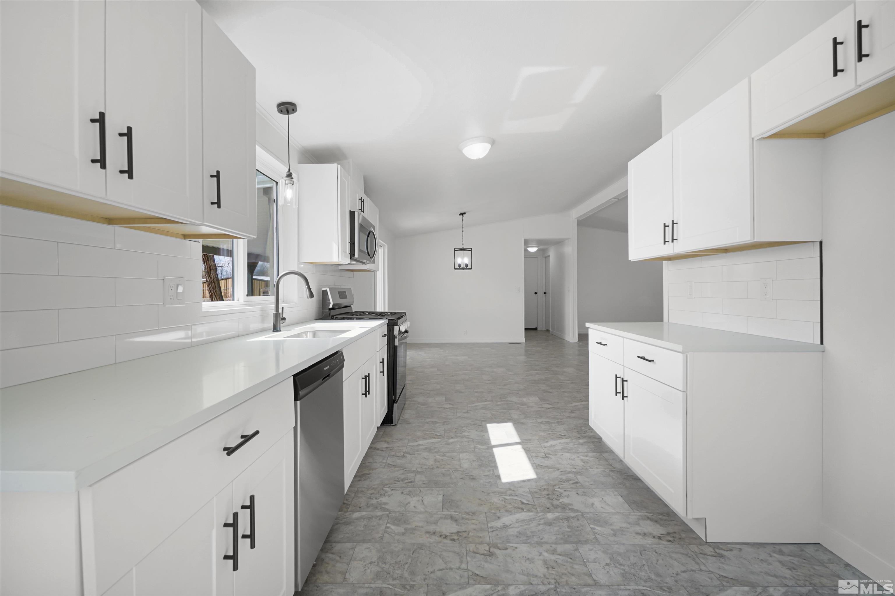 3975 Alcorn Road Fallon, NV 89406 - Photo 7 of 21 a large white kitchen with cabinets