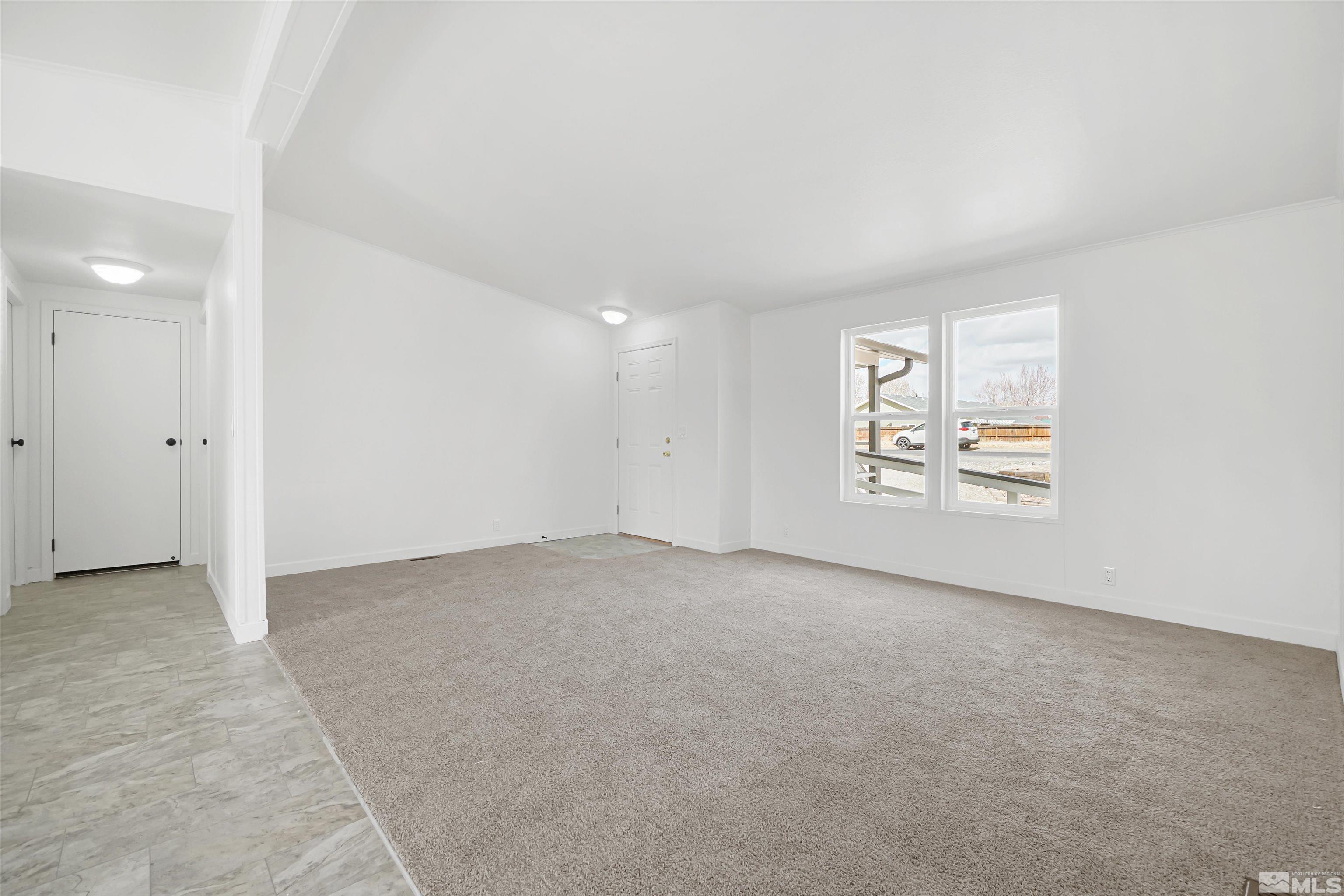 3975 Alcorn Road Fallon, NV 89406 - Photo 10 of 21 an empty room with windows and ceiling fan