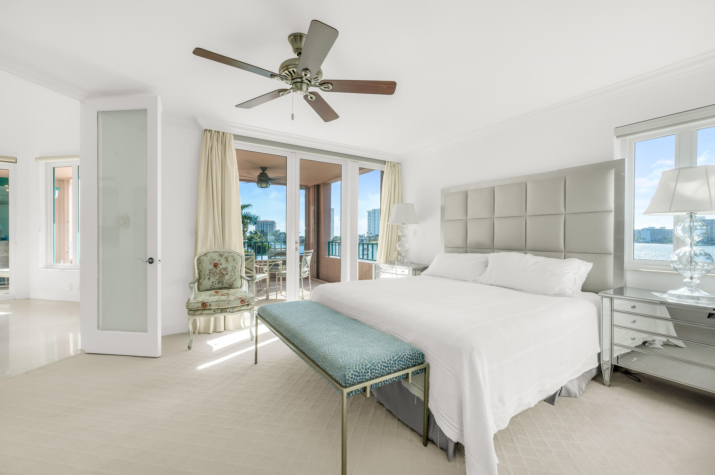 140 Southeast 5th Avenue, Unit PH50 Boca Raton, FL 33432 - Photo 9 of 52 a bedroom with a large bed and a chandelier