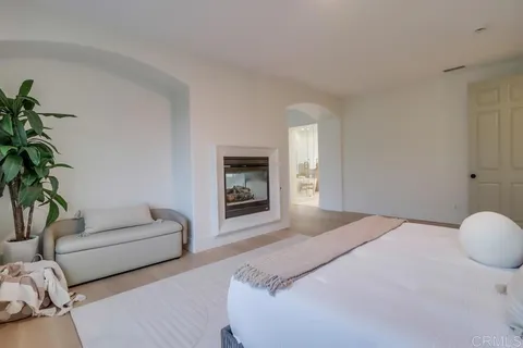 a bedroom with a bed and a potted plant