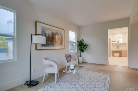 an empty room with chandelier fan and closet area