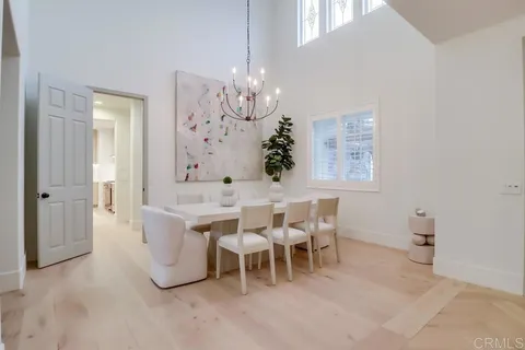 a living room with furniture chandelier and a couch