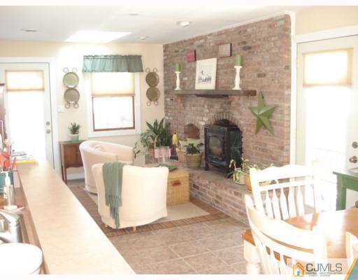 207 Princeton Road Old Bridge, NJ 08859 - Photo 2 of 10 a living room with furniture and a fireplace