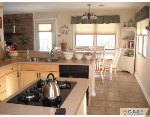 207 Princeton Road Old Bridge, NJ 08859 - Photo 3 of 10 a kitchen with granite countertop a sink and a stove top oven