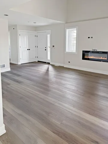 an empty room with wooden floor