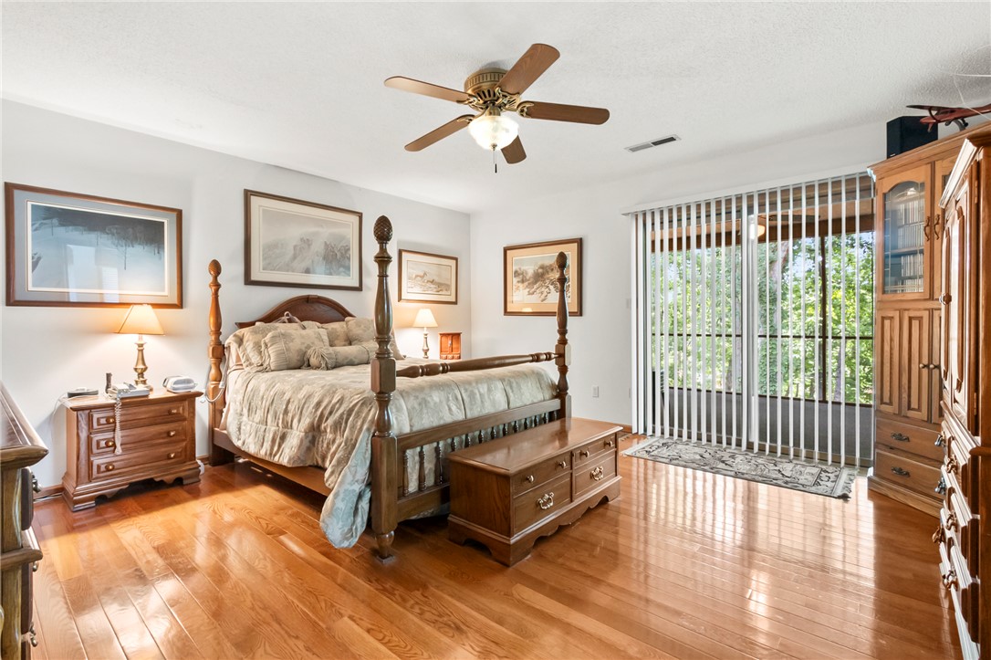 202 Plantation Point Anderson, SC 29625 - Photo 24 of 48 Hardwood floors and a tranquil outdoor view elevate this cozy primary bedroom suite.