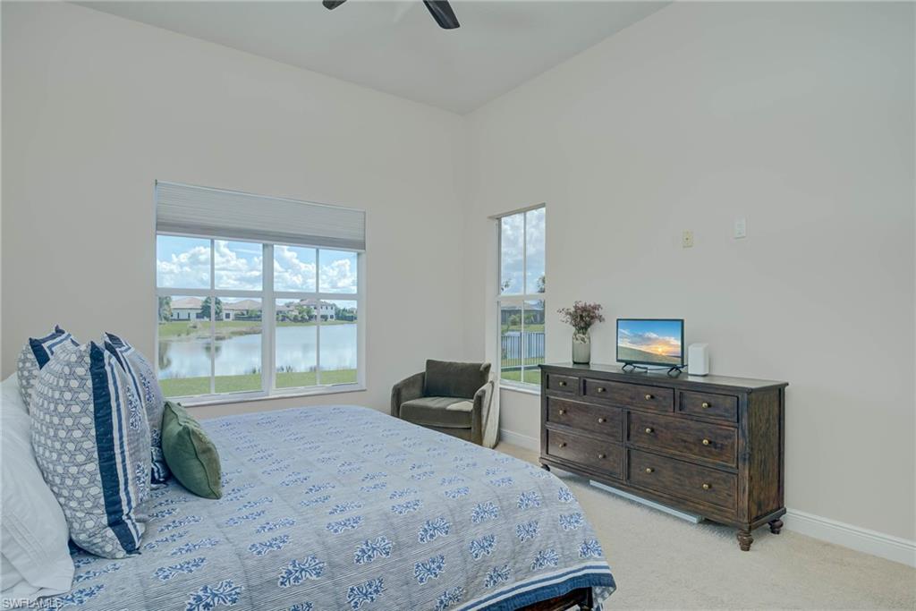 5254 Messina Street Ave Maria, FL 34142 - Photo 14 of 32 a bedroom with a bed and a dresser