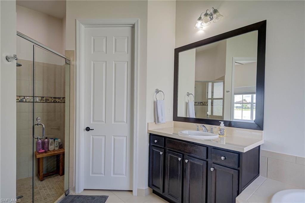 5254 Messina Street Ave Maria, FL 34142 - Photo 17 of 32 a bathroom with a double vanity sink and mirror