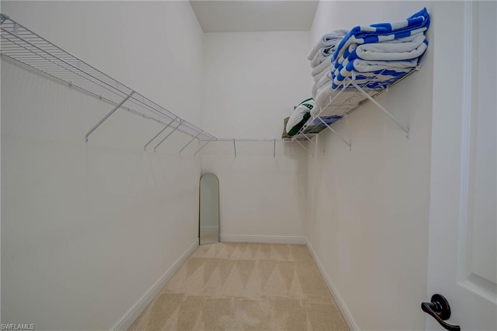 5254 Messina Street Ave Maria, FL 34142 - Photo 19 of 32 a view of a room with rack on the wall