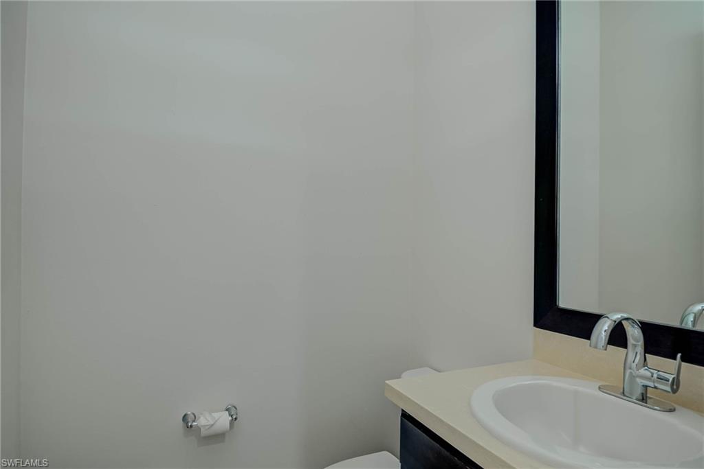 5254 Messina Street Ave Maria, FL 34142 - Photo 20 of 32 a bathroom with a sink and a mirror