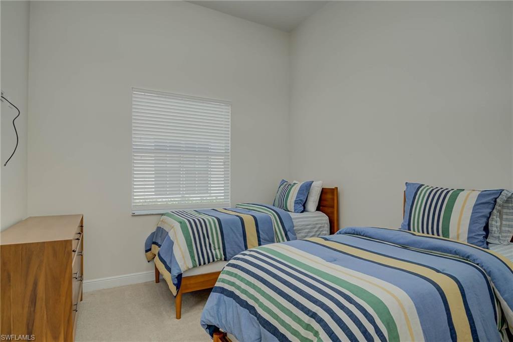 5254 Messina Street Ave Maria, FL 34142 - Photo 21 of 32 a bedroom with two beds and a window