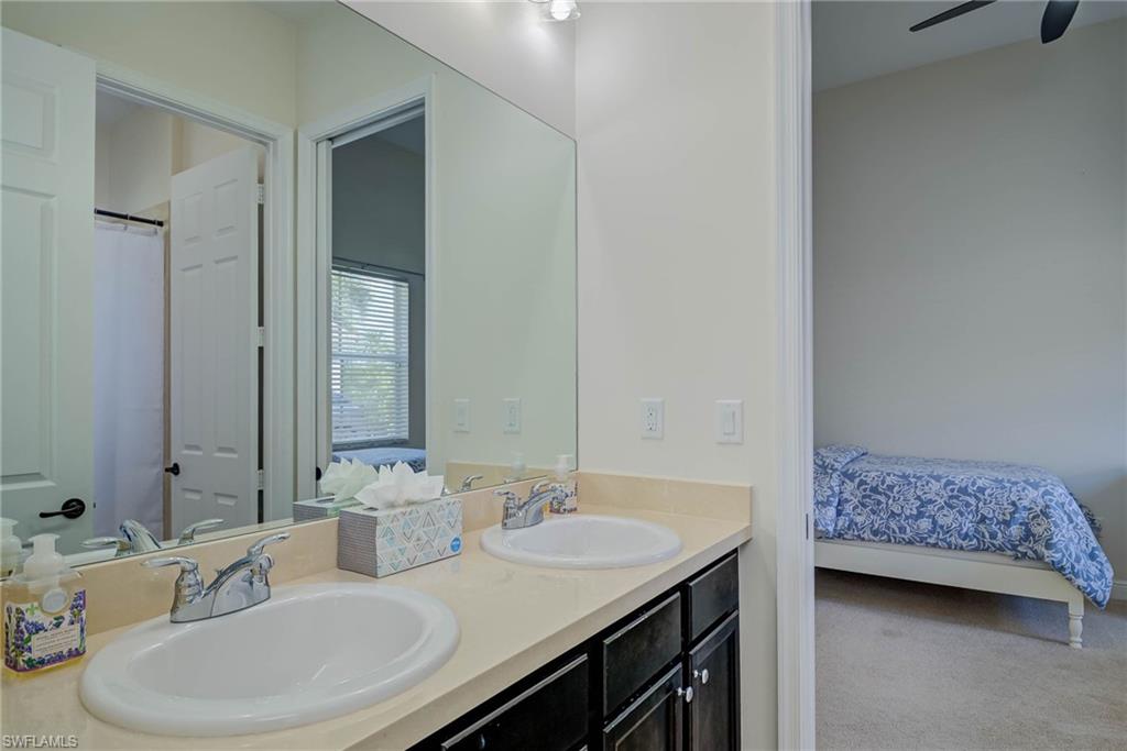 5254 Messina Street Ave Maria, FL 34142 - Photo 23 of 32 a bathroom with a sink and a mirror