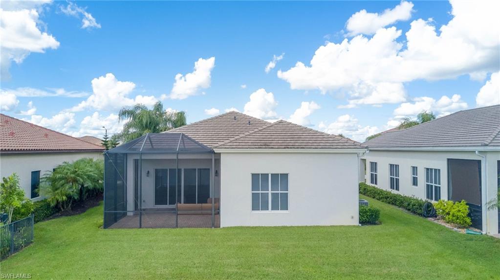 5254 Messina Street Ave Maria, FL 34142 - Photo 30 of 32 a front view of a house with a garden and yard
