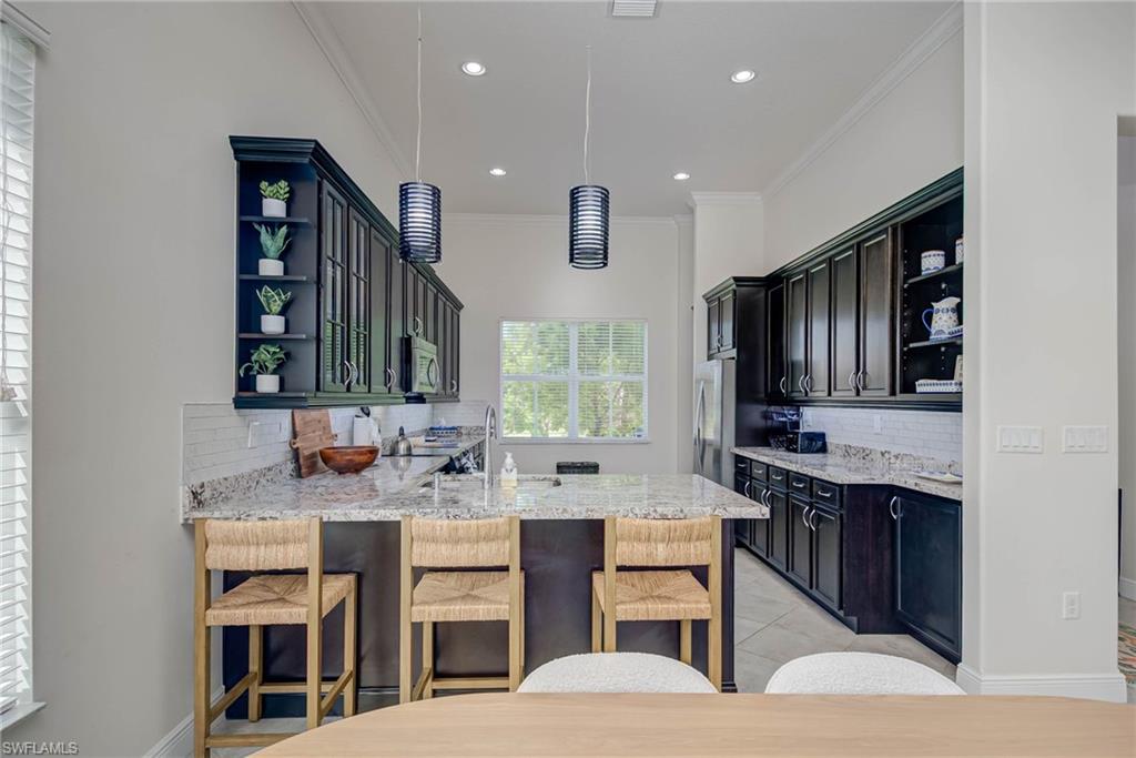 5254 Messina Street Ave Maria, FL 34142 - Photo 8 of 32 a kitchen with a sink and cabinets