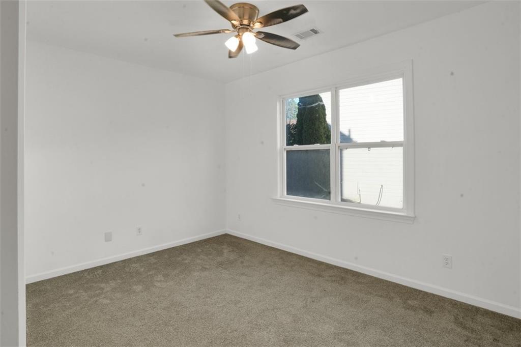 5280 Lakerock Way Southwest Atlanta, GA 30331 - Photo 13 of 33 an empty room with a window and a fan