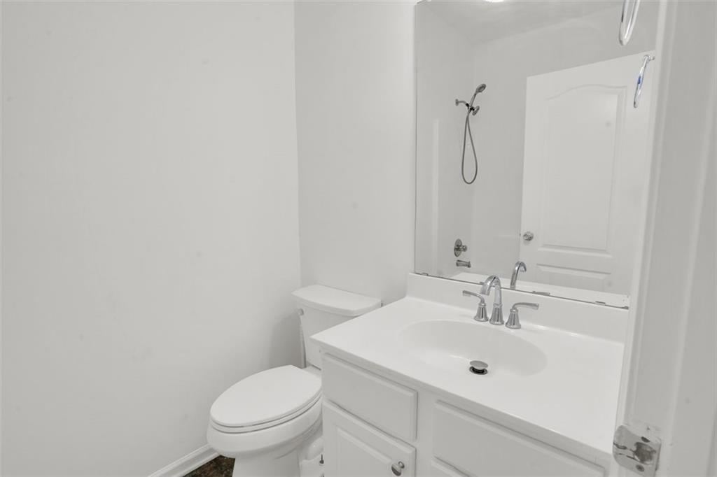 5280 Lakerock Way Southwest Atlanta, GA 30331 - Photo 14 of 33 a bathroom with a sink toilet and mirror