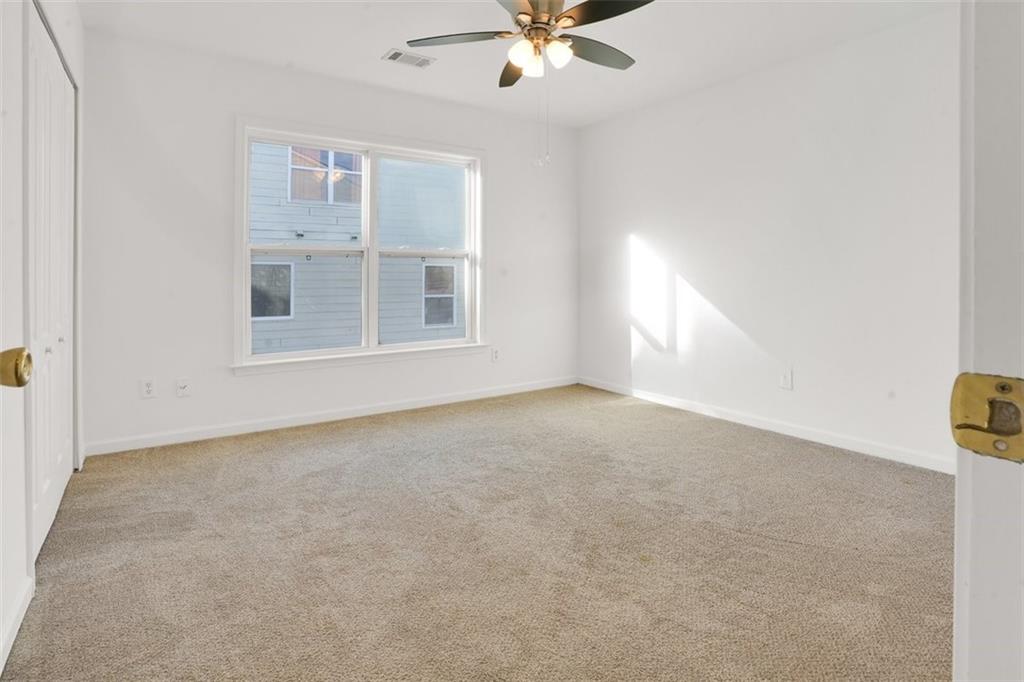 5280 Lakerock Way Southwest Atlanta, GA 30331 - Photo 21 of 33 a view of a livingroom with a ceiling fan and window