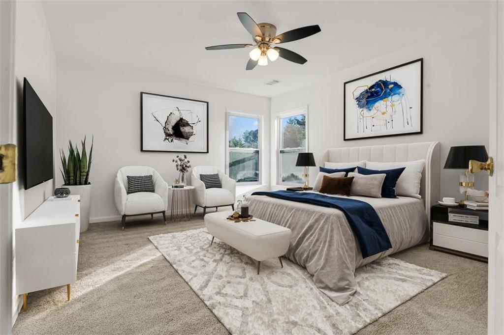 5280 Lakerock Way Southwest Atlanta, GA 30331 - Photo 24 of 33 a spacious bedroom with a bed a couch and a window