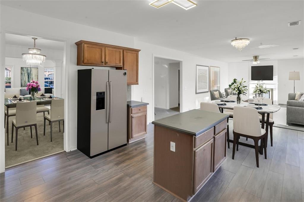 5280 Lakerock Way Southwest Atlanta, GA 30331 - Photo 3 of 33 a kitchen with kitchen island wooden floor center island and stainless steel appliances