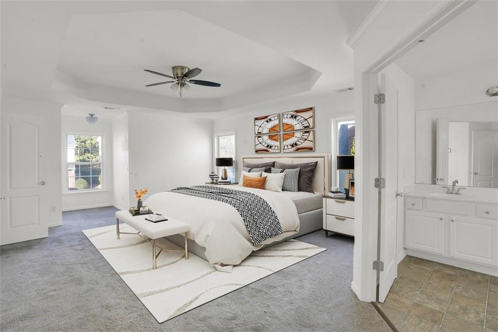 5280 Lakerock Way Southwest Atlanta, GA 30331 - Photo 4 of 33 a spacious bedroom with a bed and a chandelier