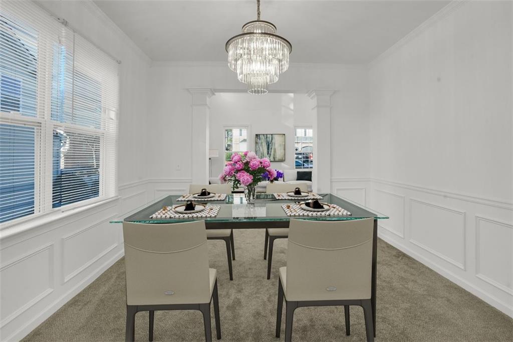 5280 Lakerock Way Southwest Atlanta, GA 30331 - Photo 9 of 33 a view of a dining room with furniture a chandelier and wooden floor
