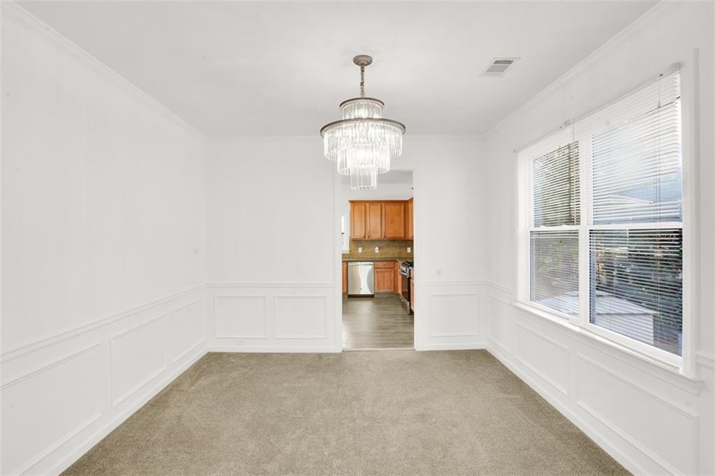 5280 Lakerock Way Southwest Atlanta, GA 30331 - Photo 10 of 33 a view of empty room with wooden floor and windows