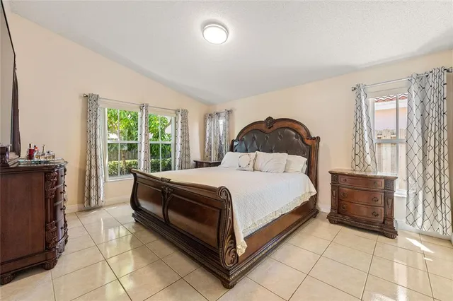 a bathroom with a double vanity sink a mirror and a bathtub