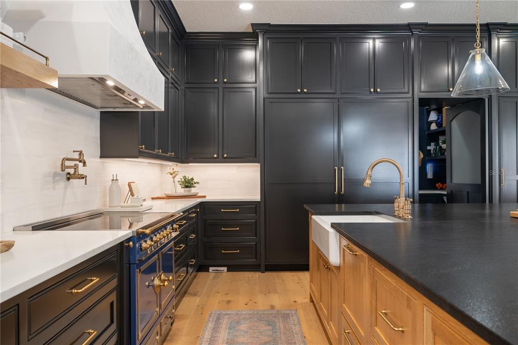5351 Carson Street St. Cloud, FL 34771 - Photo 11 of 54 a kitchen with granite countertop a sink stainless steel appliances and cabinets