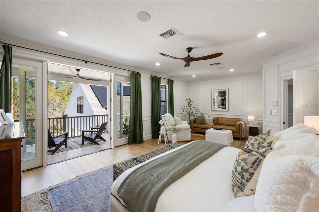 5351 Carson Street St. Cloud, FL 34771 - Photo 23 of 54 a spacious bedroom with a bed a couch and a large window