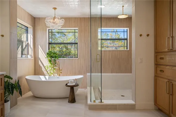 a spacious bathroom with a granite countertop sink a mirror and a bathtub