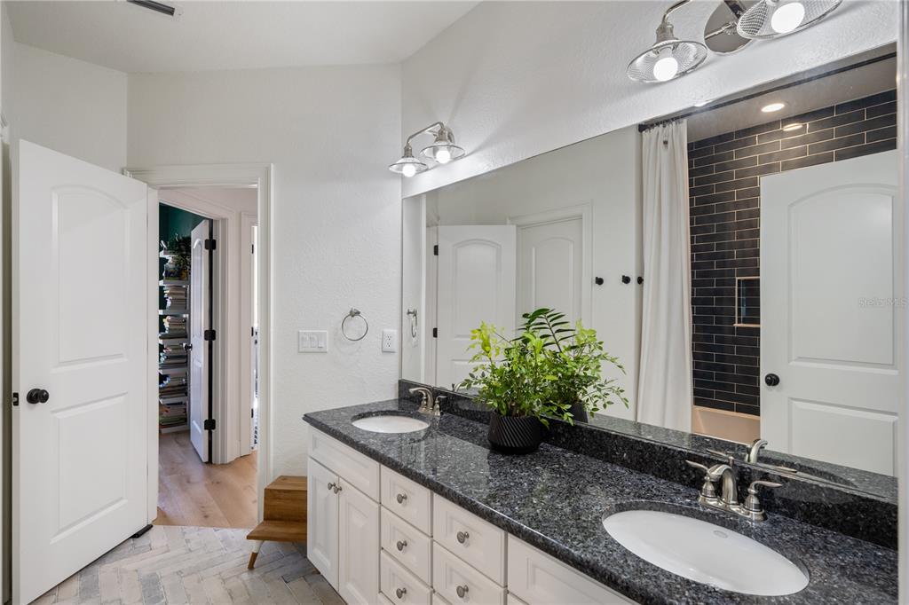 5351 Carson Street St. Cloud, FL 34771 - Photo 30 of 54 a bathroom with a granite countertop sink and a mirror