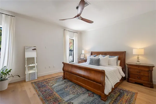 a spacious bedroom with furniture and a chandelier