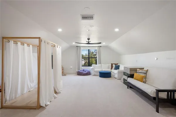 a bedroom with furniture and a large window