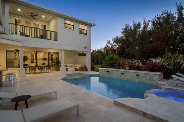 a view of a backyard with lawn chairs