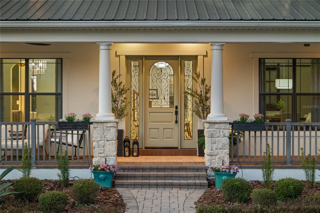 5351 Carson Street St. Cloud, FL 34771 - Photo 51 of 54 a front view of a house with a garden