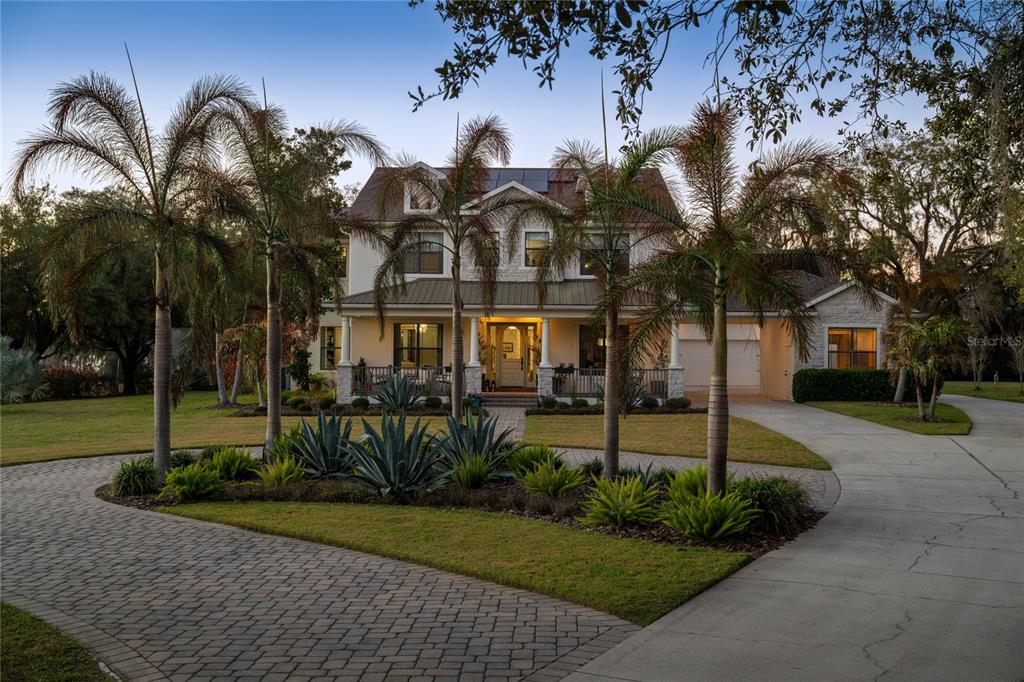 5351 Carson Street St. Cloud, FL 34771 - Photo 52 of 54 a front view of a house with a garden and trees