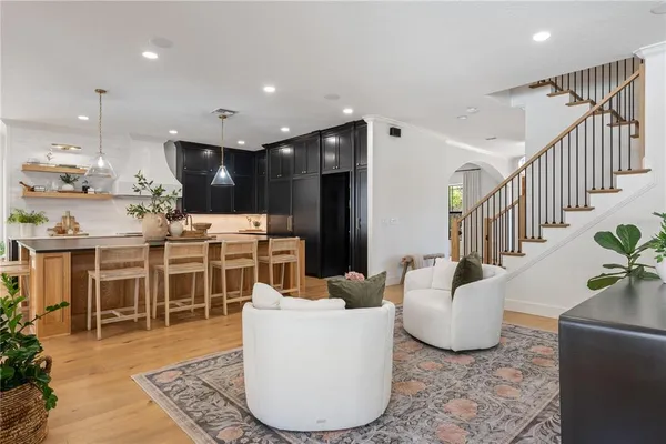a kitchen with kitchen island granite countertop wooden floor cabinets and dining table