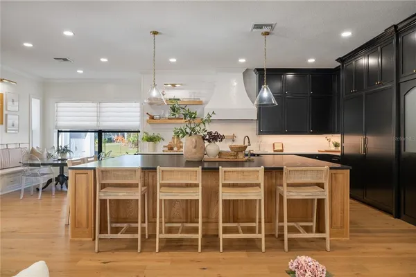a kitchen with granite countertop a sink stainless steel appliances and cabinets