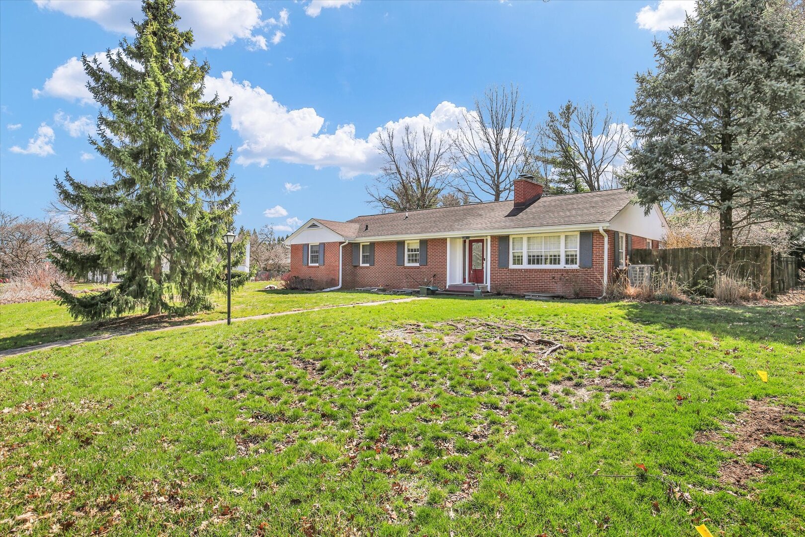 701 Hamilton Drive Champaign, IL 61820 - Photo 3 of 42 a front view of a house with a garden and trees