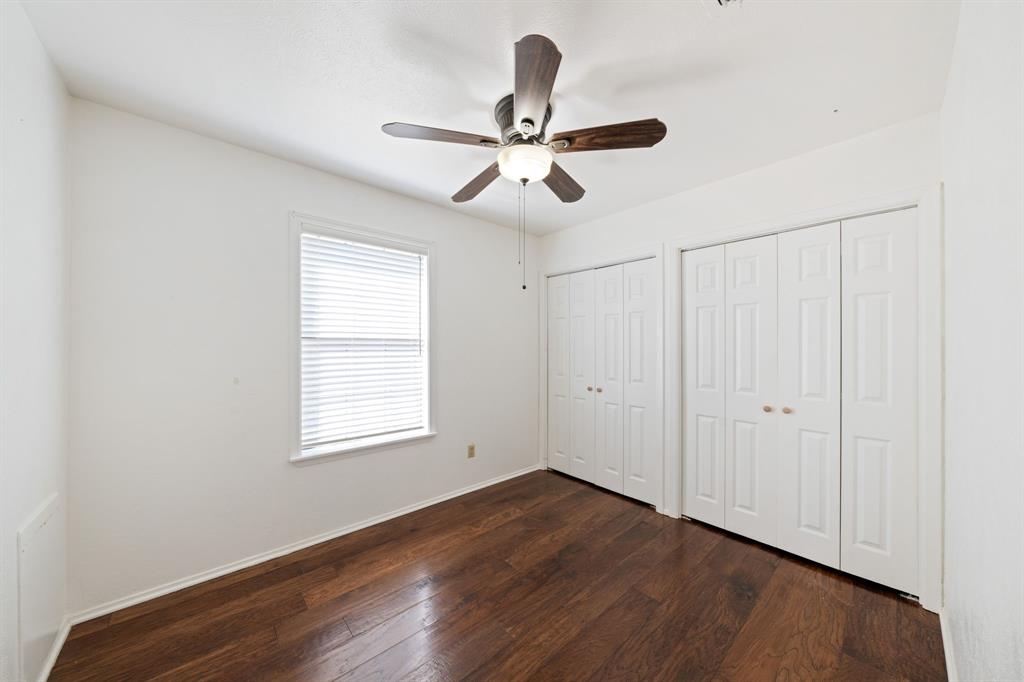 912 Crockett Street Midlothian, TX 76065 - Photo 19 of 29 an empty room with wooden floor ceiling fan and windows