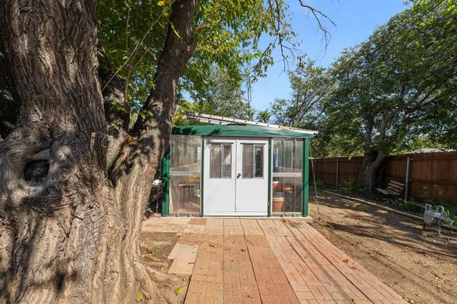 a view of house with backyard and trees