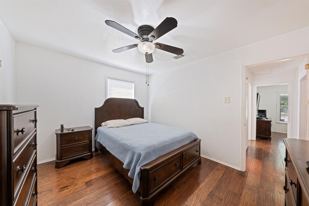 912 Crockett Street Midlothian, TX 76065 - Photo 4 of 29 a bedroom with a bed and wooden floor
