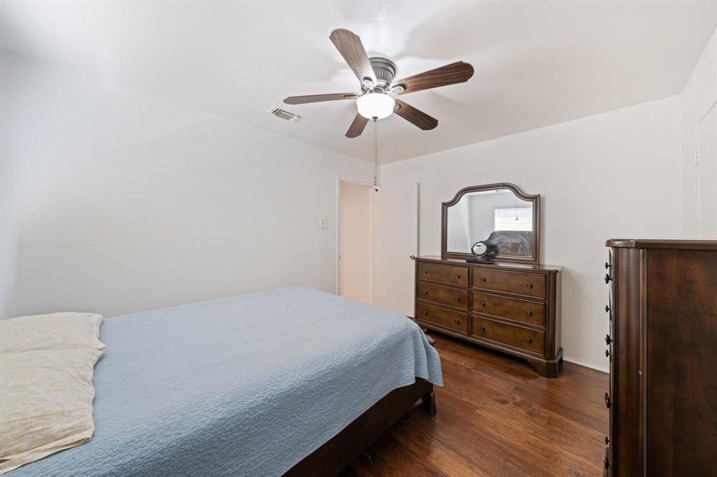 912 Crockett Street Midlothian, TX 76065 - Photo 5 of 29 a bedroom with a bed and wooden floor