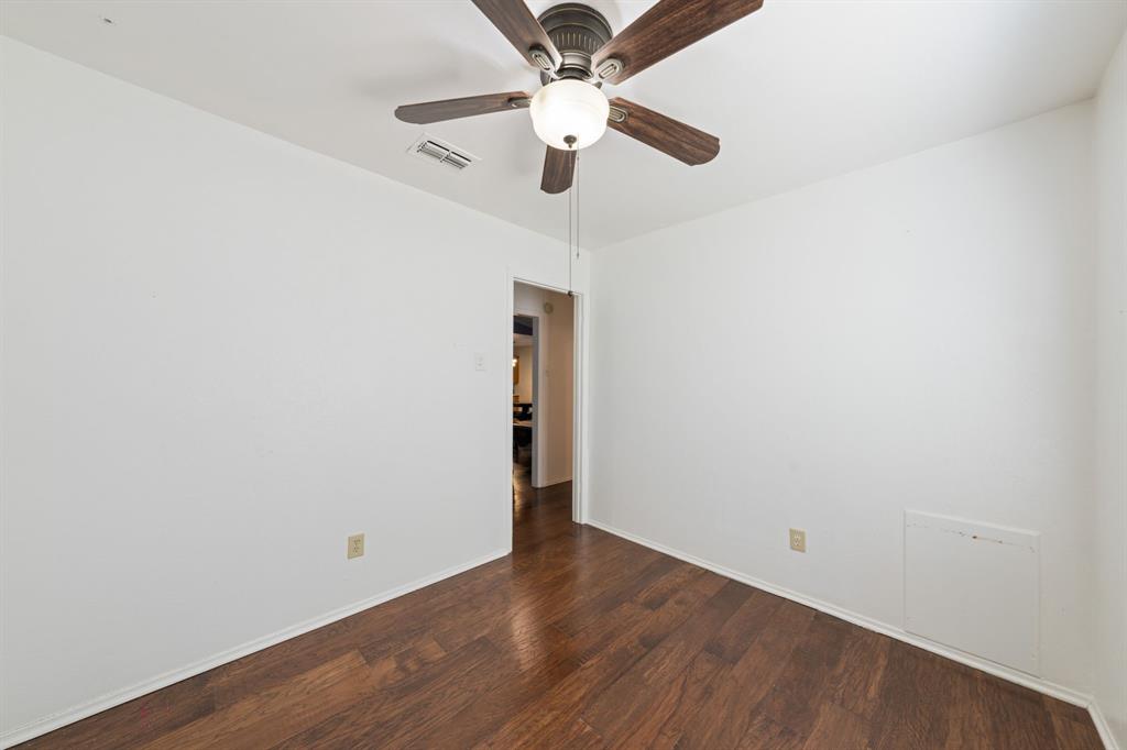 912 Crockett Street Midlothian, TX 76065 - Photo 6 of 29 an empty room with wooden floor ceiling fan and window