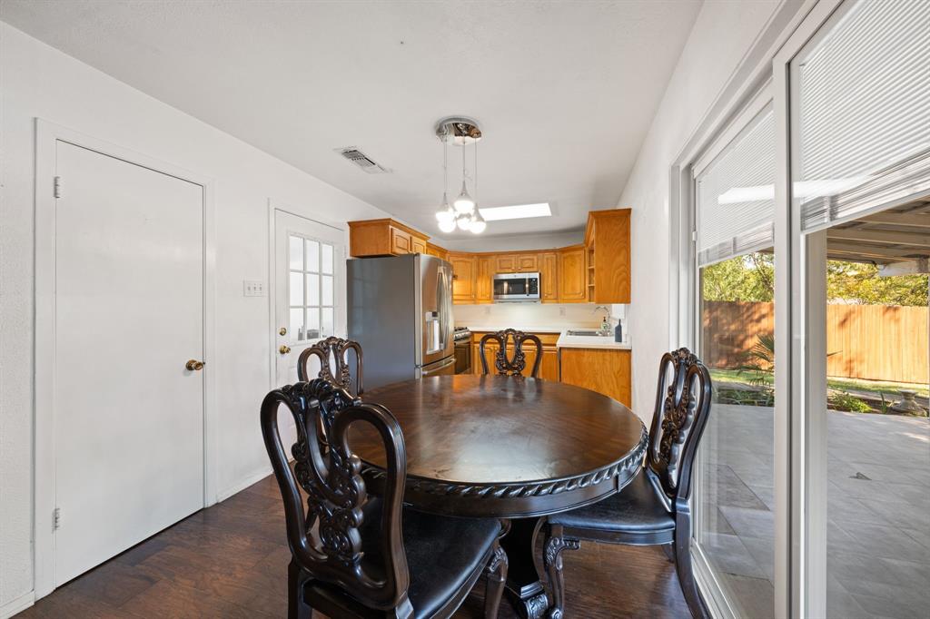 912 Crockett Street Midlothian, TX 76065 - Photo 9 of 29 a dining room with furniture a chandelier and wooden floor