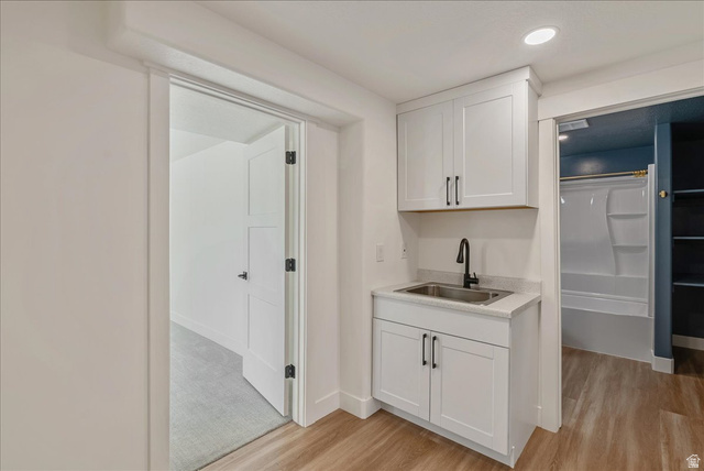 882 Spring Dew Lane Lehi, UT 84048 - Photo 43 of 46 Bar area with white cabinets, light wood-style flooring, and recessed lighting